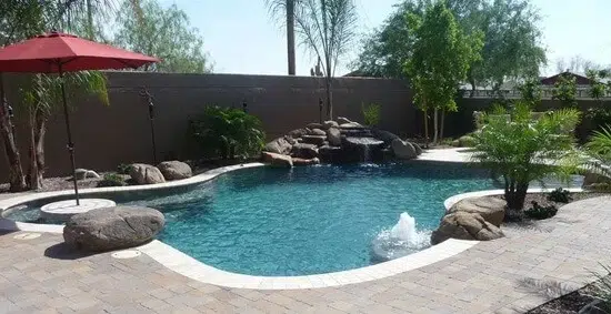 Curved pool with waterfall in Gilbert