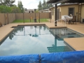Custom pool with baja steps and beach entry, Warner project — True Blue Pools