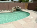 Small rock wall waterfall on a Mesa custom pool remodel by True Blue Pools