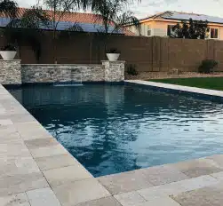 Newly installed custom pool with stone accents in Phoenix backyard